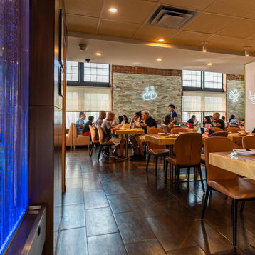 Restaurant interior with patrons, tables, and visible menu. People dining and enjoying ambiance.